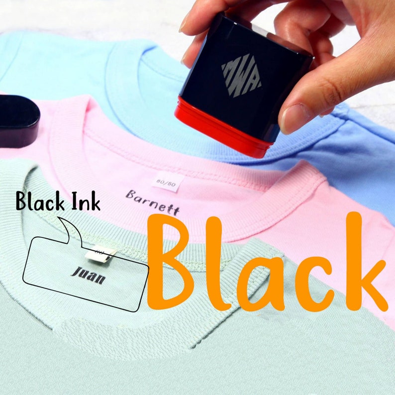 May include: A black ink stamp with a red base and a white diamond logo. The stamp is being used to label a light blue t-shirt with the name "Barnett" and a light pink t-shirt with the name "Juan". The text "Black Ink" is written in a speech bubble above the stamp. The text "Black" is written in large orange letters on the bottom of the image.
