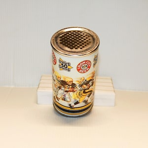 May include: A white metal can with a gold top and a black and yellow band around the middle. The can features a graphic of football players wearing Pittsburgh Steelers uniforms and the text "Steelers 50 Seasons" and "Iron City Beer".