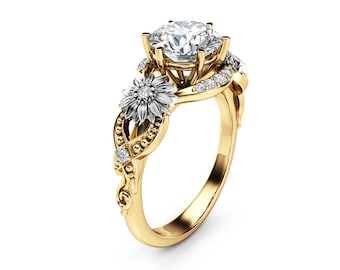 May include: A gold ring with a large round diamond center stone and two smaller diamond flower accents on the band.