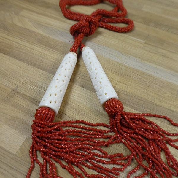 Gorgeous Art Deco Coral glass micro beaded Lariat necklace, with carved Bone ends and tassels.