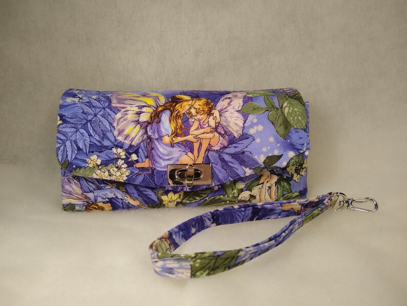 Magical Fairies adorn this accordionexpandable wallet!
