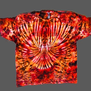 May include: A tie-dye t-shirt with a red, orange, and black swirl pattern. The shirt has a crew neck and short sleeves.