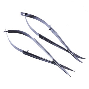 May include: Two surgical micro scissors with curved blades and finger loops. The stainless steel scissors have serrated handles for a secure grip. The tips are pointed and designed for precision cutting in medical or scientific applications.