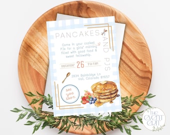 May include: A light blue and white gingham patterned invitation for a pancake and pajama party. The invitation includes text, a stack of pancakes with butter, and berries. The invitation is on a wooden plate with greenery.