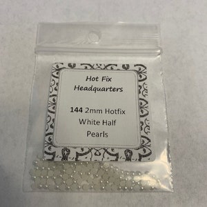 May include: A bag of 144 white half-round 2mm hot fix pearls. The bag is labeled "Hot Fix Headquarters 144 2mm Hotfix White Half Pearls".