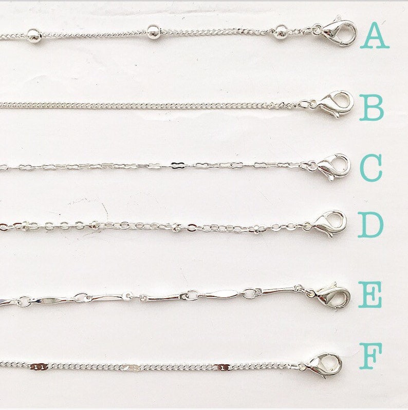 May include: Six different silver chains with clasps, labeled A through F.