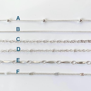 May include: Six different types of silver chains, labeled A through F, are displayed on a white background. The chains are all approximately the same length and are arranged in a vertical row.