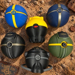 May include: A collection of five spherical and semi-spherical objects with various designs. One is blue with a yellow stripe and the number 33, another is dark blue with a gold stripe and 111, one is yellow and black, one is matte black, and one is olive green.