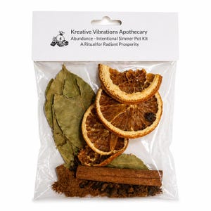 May include: A clear plastic bag containing dried orange slices, bay leaves, a cinnamon stick, and a blend of spices. The bag is labeled "Kreative Vibrations Apothecary" with text that reads "Abundance - Intentional Simmer Pot Kit".