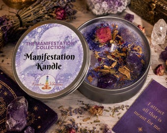 May include: A round metal tin candle with a purple label reading The Manifestation Collection Manifestation Kandle Kreative Vibrations. The wax is topped with purple glitter, dried flower buds, and amethyst crystals, with a single white wick.