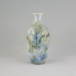 May include: A ceramic vase with a light blue, white and brown glaze. The vase has an oval shape and a narrow neck.