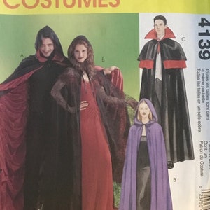 May include: McCall's Costumes pattern featuring hooded capes and cloaks. The image shows a variety of costume designs, including a black cape with a red lining, a red dress, and a purple hooded cloak. The pattern is labeled "Easy" and can be completed in 2 hours.