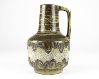 May include: A brown and green ceramic vase with a wavy design and a handle. The vase has a textured surface and a slightly flared opening.