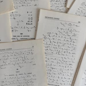 以下が含まれることがあります： 手書きの速記とテキストが書かれた、ヴィンテージの紙のコレクション。紙はオフホワイトで、「Dictation Course」や「The Use of Leisure」などの見出しがあります。一部のページには数字と金額が記載されています。