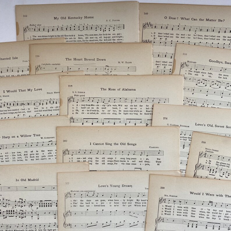 May include: A collection of vintage sheet music featuring popular songs like "My Old Kentucky Home", "The Rose of Alabama", "Love's Young Dream", and "Would I Were with Thee". The music sheets are yellowed with age and have handwritten notes on them.