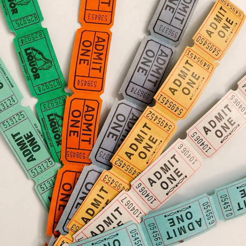 May include: A close-up of a collection of vintage paper admission tickets. The tickets are in various colors, including blue, green, yellow, and orange. The tickets have the words "ADMIT ONE" printed on them, along with a variety of numbers and other text.