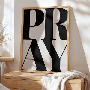 Minimalist Christian prayer wall art styled in modern neutral home interior.