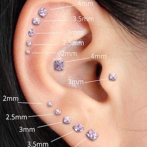 May include: An ear with several pink gemstone stud earrings, sized from 2mm to 4mm. The image displays the earrings' placement, with measurements in millimetres, demonstrating size variations for ear piercing jewellery.