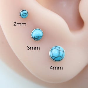 May include: Three round stud earrings with a turquoise stone inlay featuring black veining, set in a silver-toned metal base. The studs are labeled with their respective sizes of 2mm, 3mm, and 4mm, showing the variation in diameter for each piece.