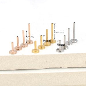 May include: A set of 9 gold and silver body jewelry studs in three different lengths: 5mm, 6mm, and 8mm. The studs are made of surgical steel and are available in a variety of colors.