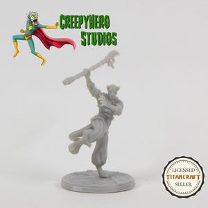 May include: A gray miniature figure of a character holding a staff, posed in a dynamic stance. The figure is on a circular base. The image includes the text "CREEPYHERO STUDIOS" and a cartoon character.