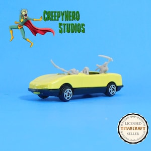 May include: A yellow and black toy convertible car with a gray interior. The car has black wheels and a black trim. The image also includes the text "CREEPYHERO STUDIOS" and a cartoon character.