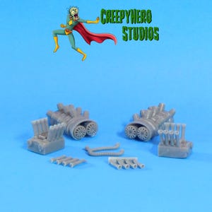 May include: Gray model engine parts, including two engine blocks with dual wheels, exhaust manifolds, and other components. The image features the text "CREEPYHERO STUDIOS" and a cartoon character on a blue background.