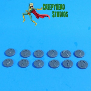 May include: A collection of gray, circular tokens, each featuring a raised question mark symbol. The tokens are arranged on a blue background. The image also includes a cartoon superhero character and the text "CREEPYHERO STUDIOS".