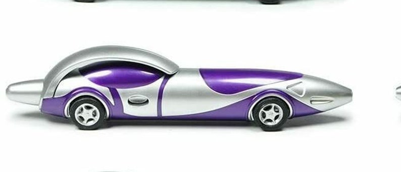 May include: A silver and purple car-shaped pen. The pen has a sleek, futuristic design with a purple body and silver accents.