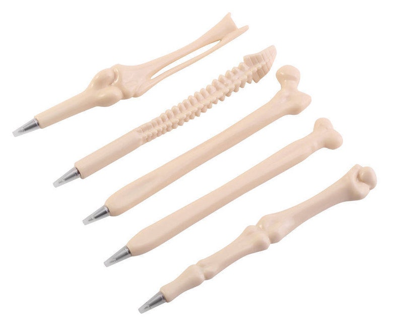 May include: Five bone-shaped pens in various styles, including a ribcage, spine, and femur. The pens are all made of a light beige plastic and have a realistic bone texture.