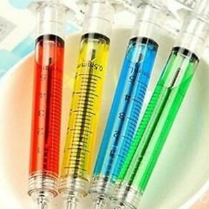 May include: Four plastic syringe pens with colorful ink. The pens are red, yellow, blue, and green.