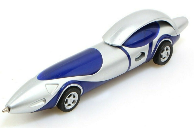 May include: A silver and blue pen shaped like a futuristic race car. The pen has a blue body with a silver top and a silver stripe down the side. The pen has black wheels and a silver tip.