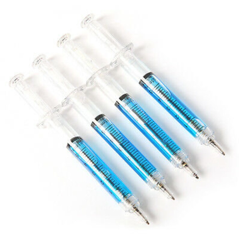 May include: Five clear plastic syringe-shaped pens with blue ink. The pens are arranged in a row, with the tips of the pens pointing to the right.