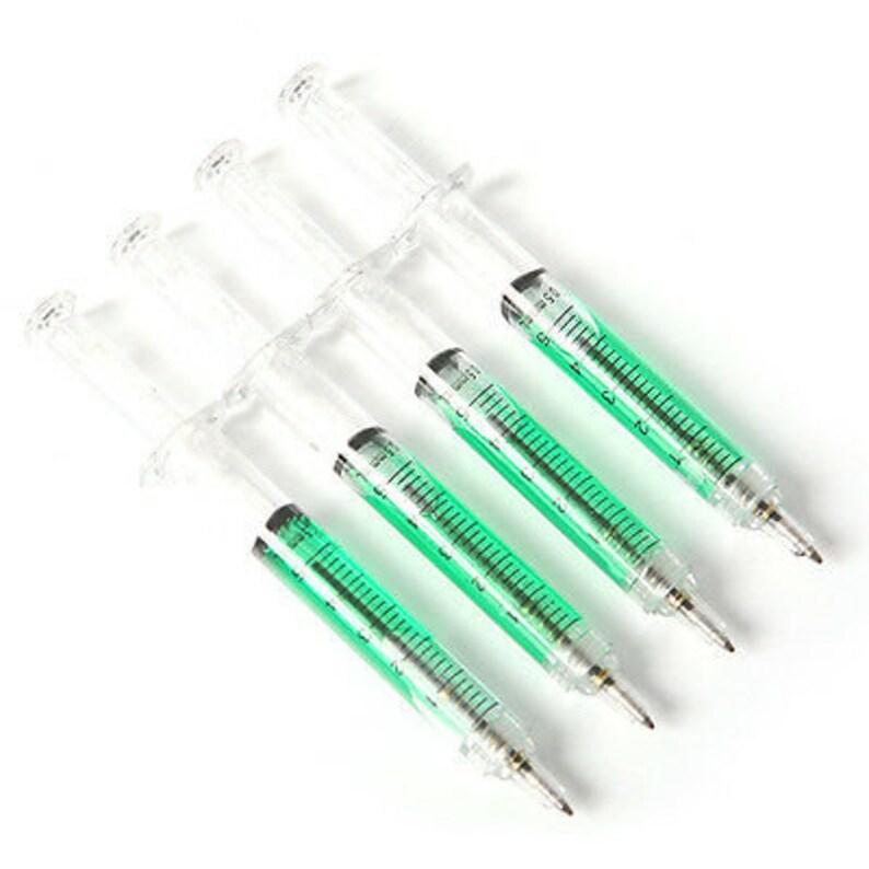 May include: Five clear plastic syringe pens with green ink. The pens are arranged in a row, with the tips pointing to the right.