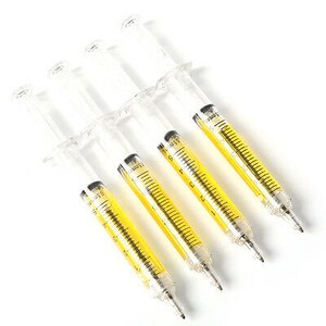 May include: Set of five clear plastic syringe pens with yellow ink. The pens have black markings and are arranged in a row.