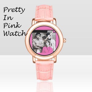 May include: A pink watch with a rose gold case and a pink leather band. The watch face features a black and white image of three people and the words "Pretty in Pink". The watch band is approximately 0.75 inches wide.