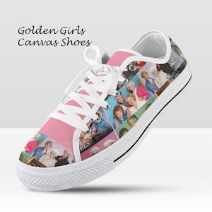 May include: Pink canvas shoes with a collage of images of the Golden Girls. The shoes have white laces, a white rubber toe cap, and a black stripe along the sole. The text "Golden Girls Canvas Shoes" is printed on the side.