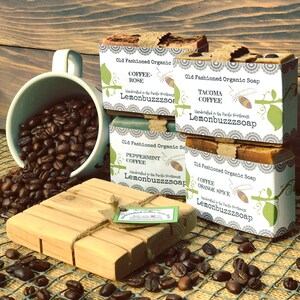May include: Four bars of handmade organic coffee soap with different scents: Coffee Rose, Tacoma Coffee, Peppermint Coffee, and Coffee Orange Spice. Each bar is wrapped in white paper with a green vine and bee design. The text "Lemonbuzzzsoap" is printed on each bar.