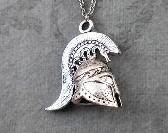 May include: Silver necklace with a detailed pendant of a Greek warrior helmet with a plume.