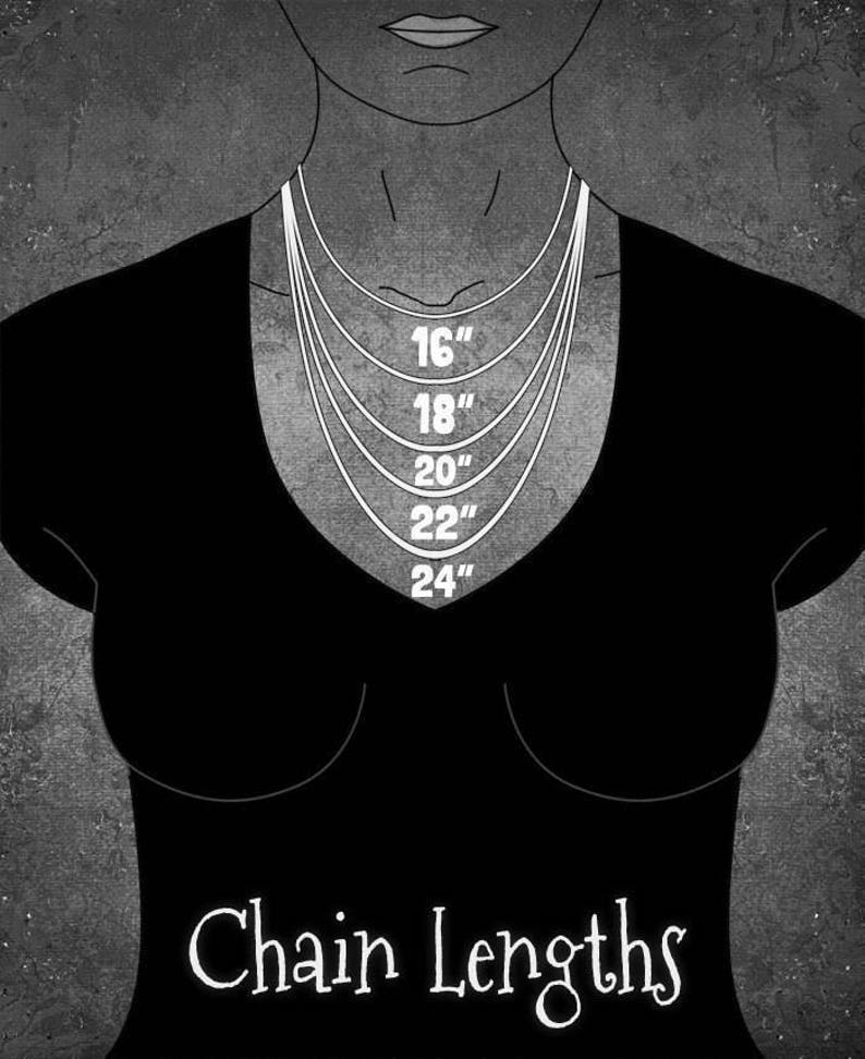 May include: A black and white illustration of a person wearing a black shirt with a chain necklace. The necklace is shown in different lengths, labeled 16", 18", 20", 22", and 24". The text "Chain Lengths" is below the illustration.
