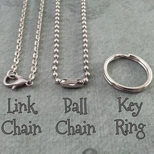 May include: Three silver-coloured jewellery findings: a link chain with a lobster clasp, a ball chain, and a key ring. The text below each item reads "Link Chain", "Ball Chain", and "Key Ring".