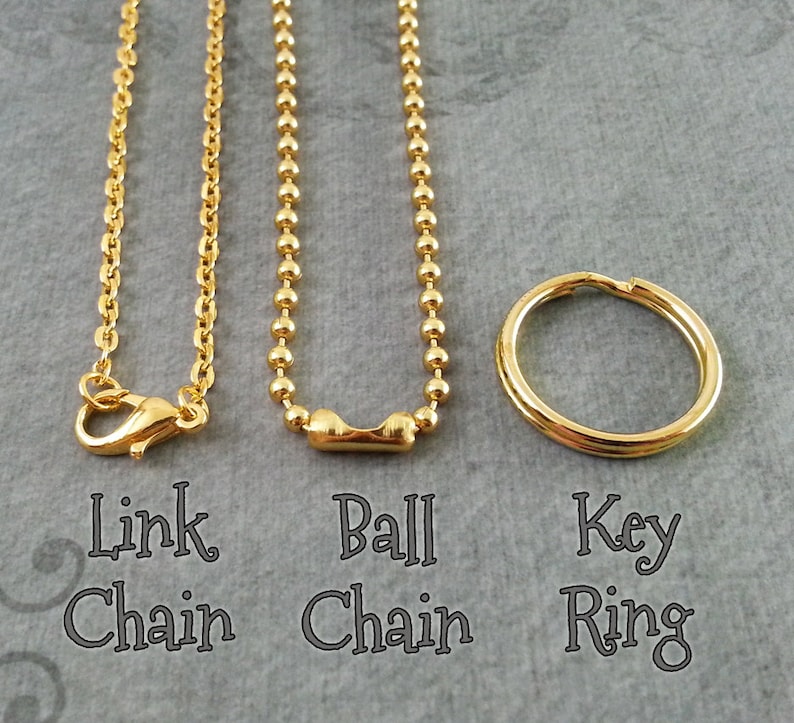 May include: Three gold-colored jewelry findings: a link chain with a lobster clasp, a ball chain, and a key ring. The text below each item reads "Link Chain", "Ball Chain", and "Key Ring".