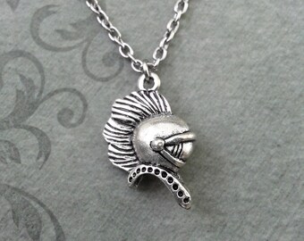 May include: Silver necklace with a detailed pendant of a knight's helmet.