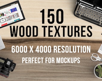 May include: A close-up of a wooden surface with the text "150 WOOD TEXTURES 6000 X 4000 RESOLUTION PERFECT FOR MOCKUPS" on it. There are various objects on the surface, including a laptop, a typewriter, a camera, a phone, a pair of scissors, a potted plant, and a notepad.