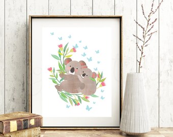 May include: A framed print of two koalas hugging, surrounded by green leaves and pink flowers. Blue butterflies are scattered around the koalas.