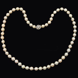 May include: A classic pearl necklace with a silver clasp. The pearls are white and round, and the necklace is about 18 inches long.