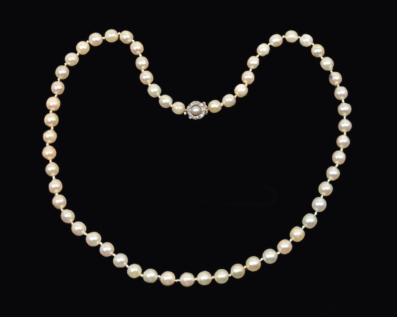 May include: A classic pearl necklace with a silver clasp. The pearls are white and round, and the necklace is about 18 inches long.