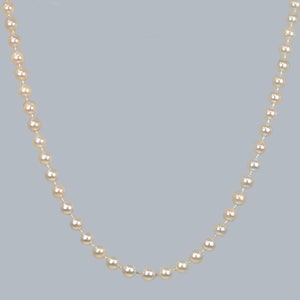 May include: A strand of white pearls strung together on a silver chain.