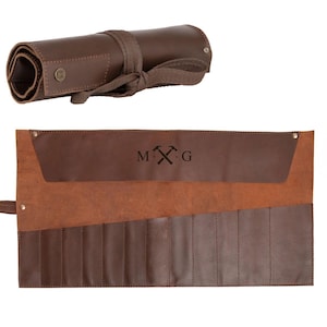 May include: Brown leather tool roll with 10 slots for tools. The roll has a flap with a brown leather pocket and a personalised inscription that reads "M.X.G".