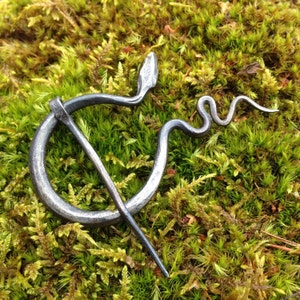 Penannular brooch, hand forged "snake" design.